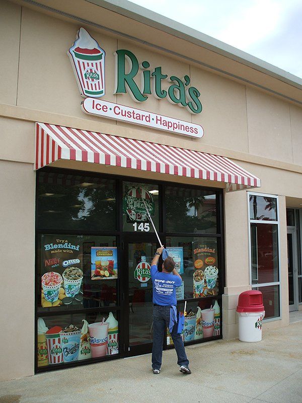 Wipe Out Windows Staff Cleaning Rita's Shop Windows — Fort Myers, FL — Wipe Out Windows