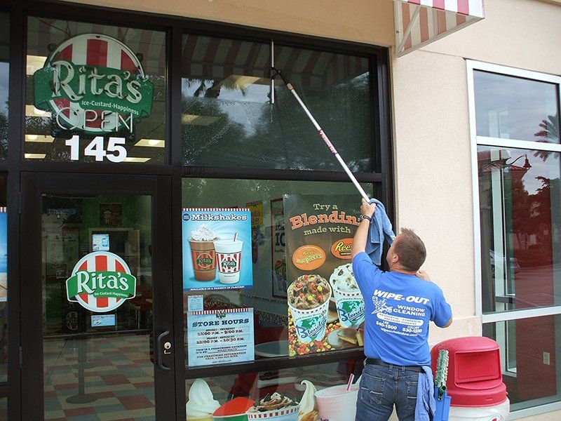 Wipe Out Windows Staff Cleaning Shop Windows — Fort Myers, FL — Wipe Out Windows