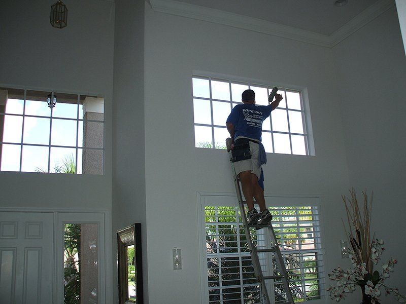 Man Cleaning Residential House Windows — Fort Myers, FL — Wipe Out Windows