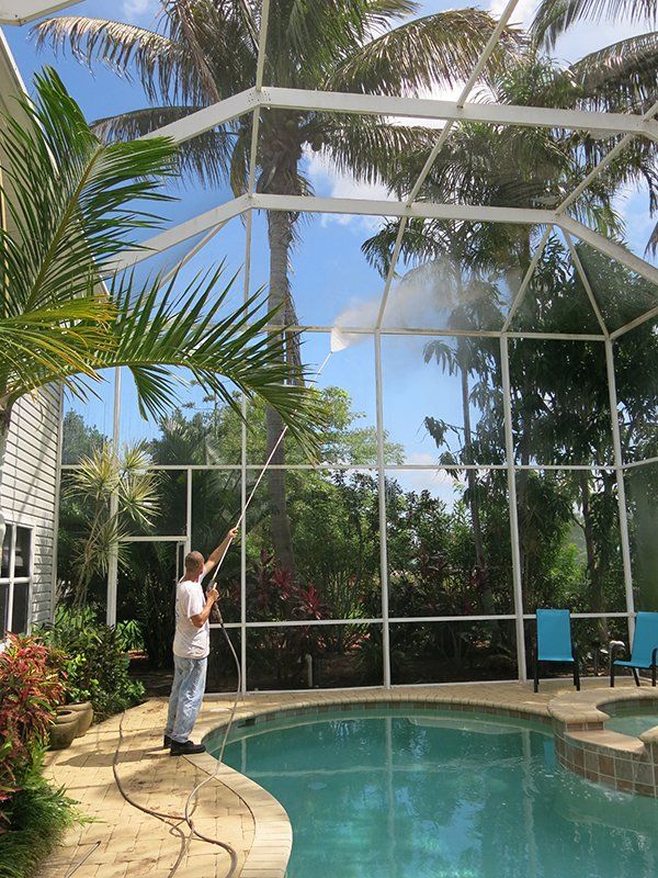 Man Using Pressure Washer — Fort Myers, FL — Wipe Out Windows