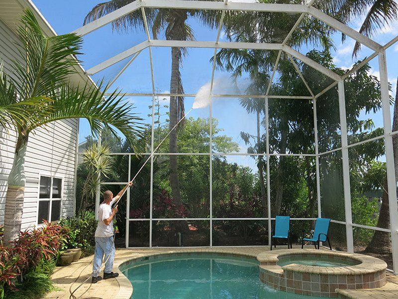 Man Cleaning Lanai Enclosure — Fort Myers, FL — Wipe Out Windows