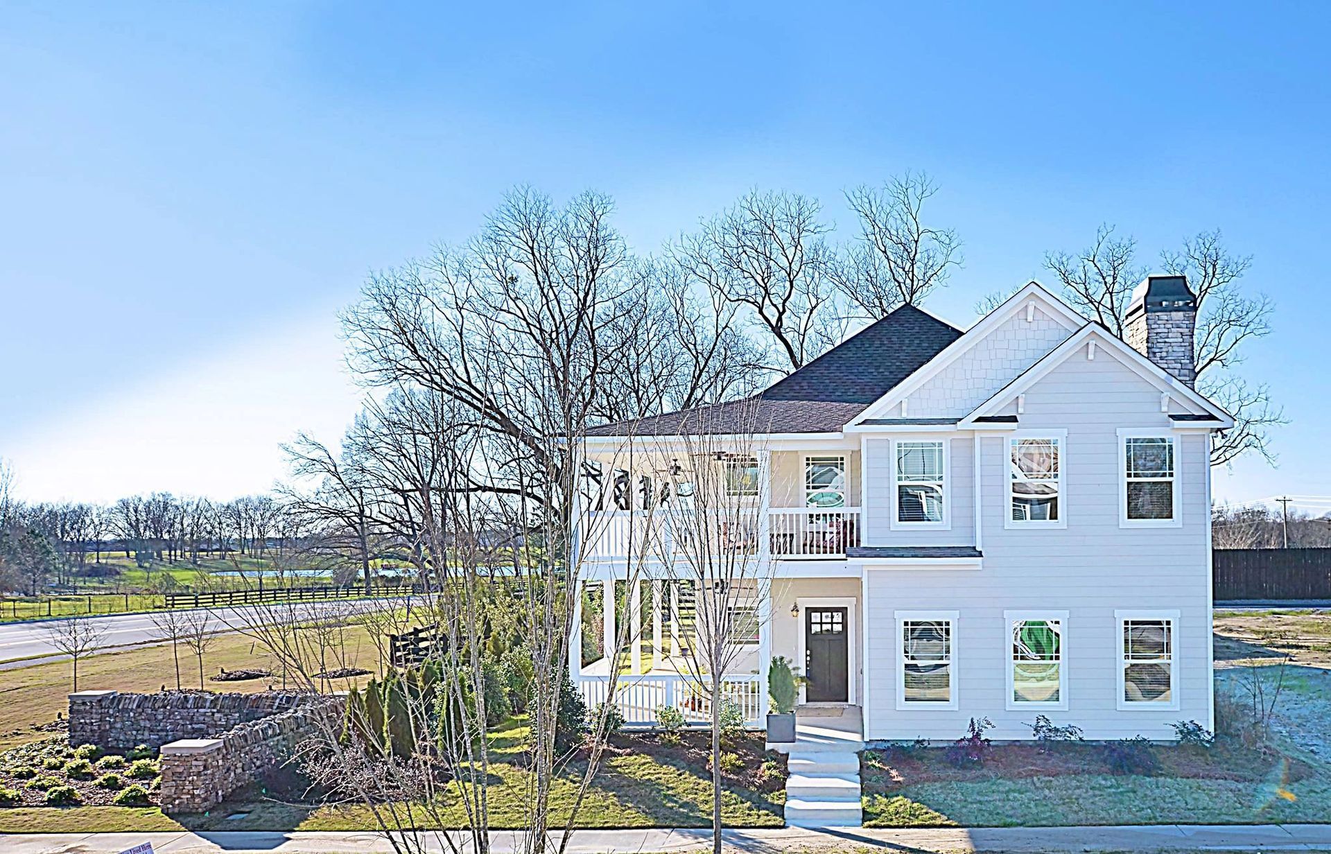 An aerial view of a large white house with a lot of windows.