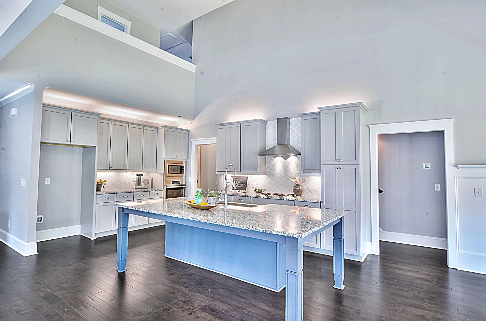 A kitchen with a large island in the middle of it.