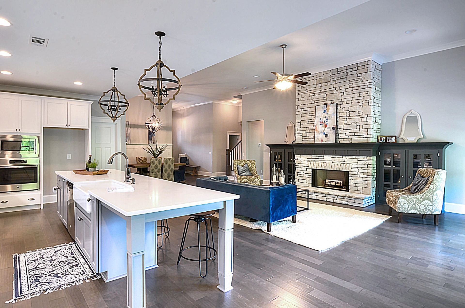 A kitchen , living room , and fireplace in a house.