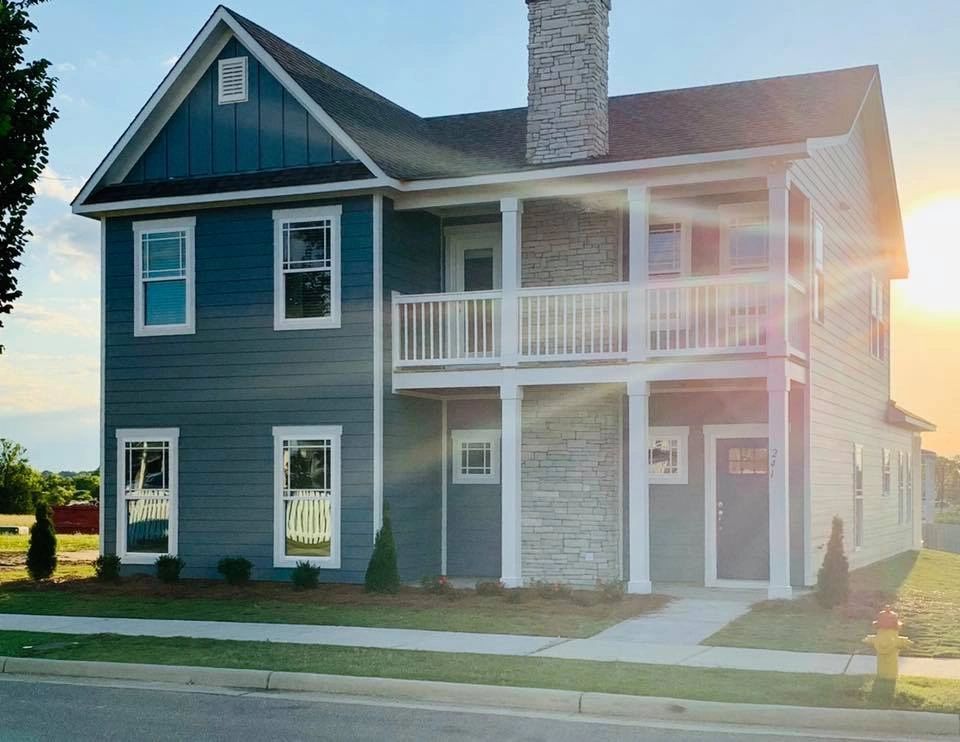 A large house with a balcony and a chimney