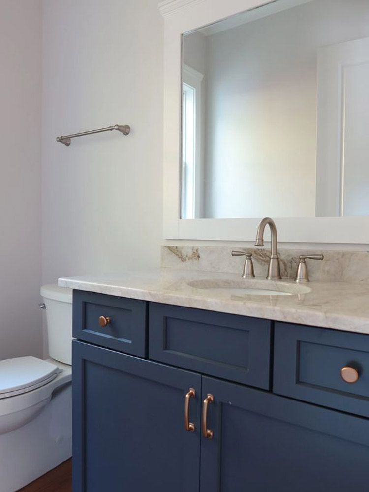 A bathroom with a sink toilet and mirror