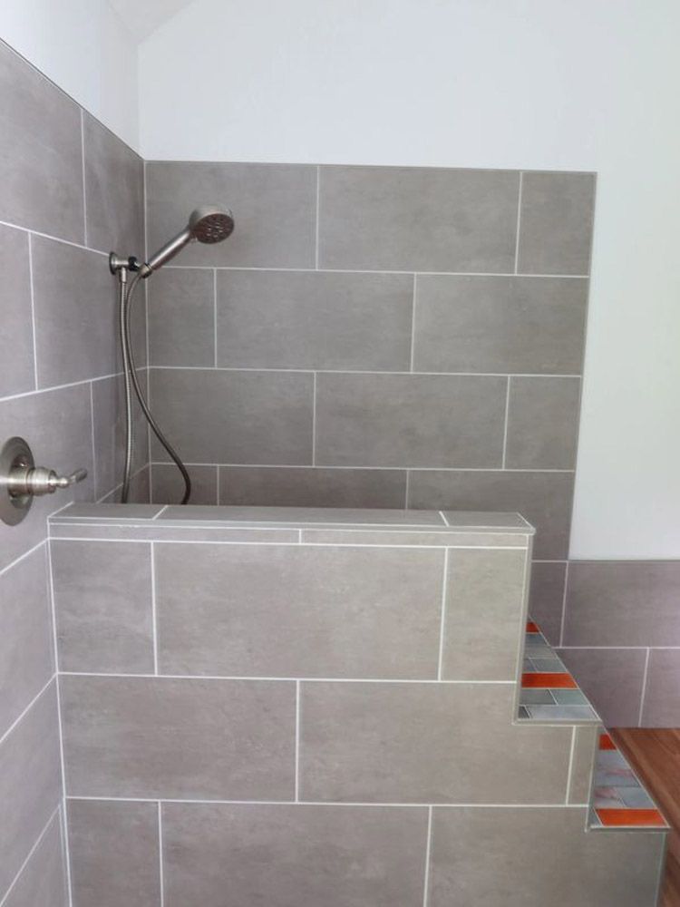 There is a shower with a shower head in it.