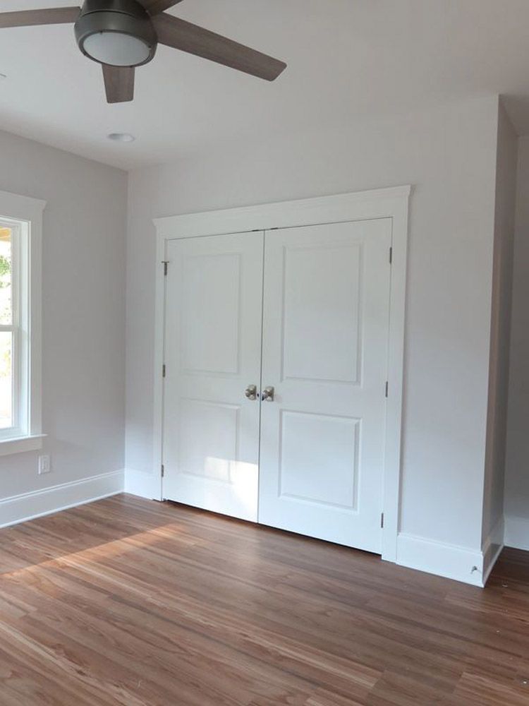 There is a ceiling fan in the corner of the room.