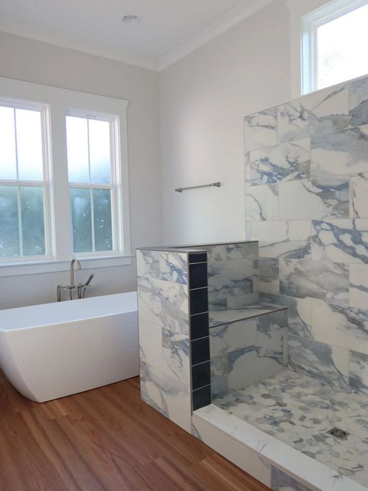 A bathroom with a bathtub and a walk in shower