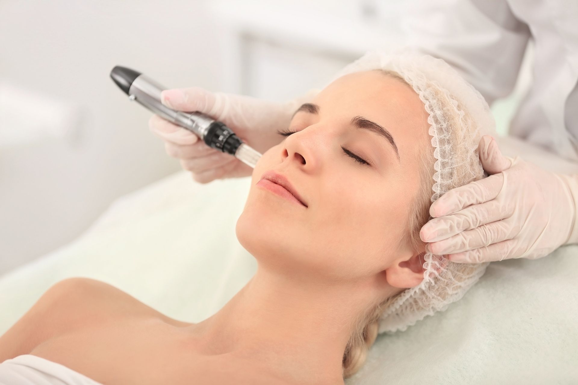 a woman is getting a microdermabrasion treatment on her face.