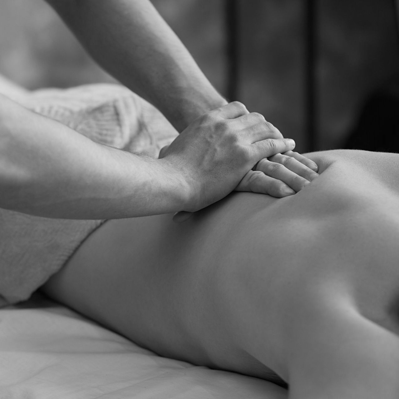 A black and white photo of a person getting a massage.