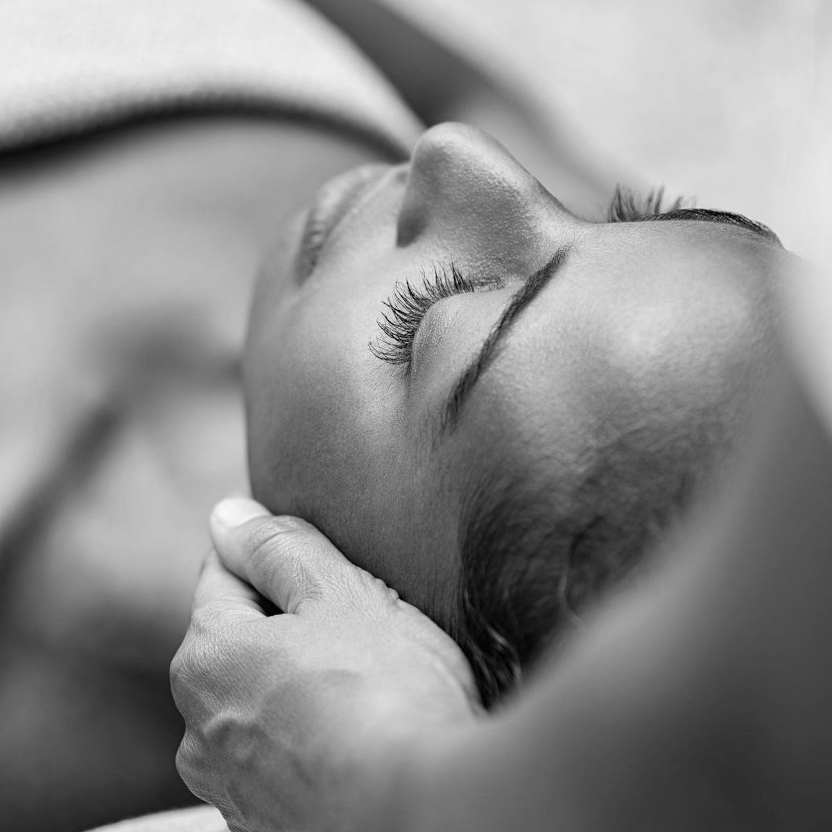 a close up of a woman getting a massage on her face
