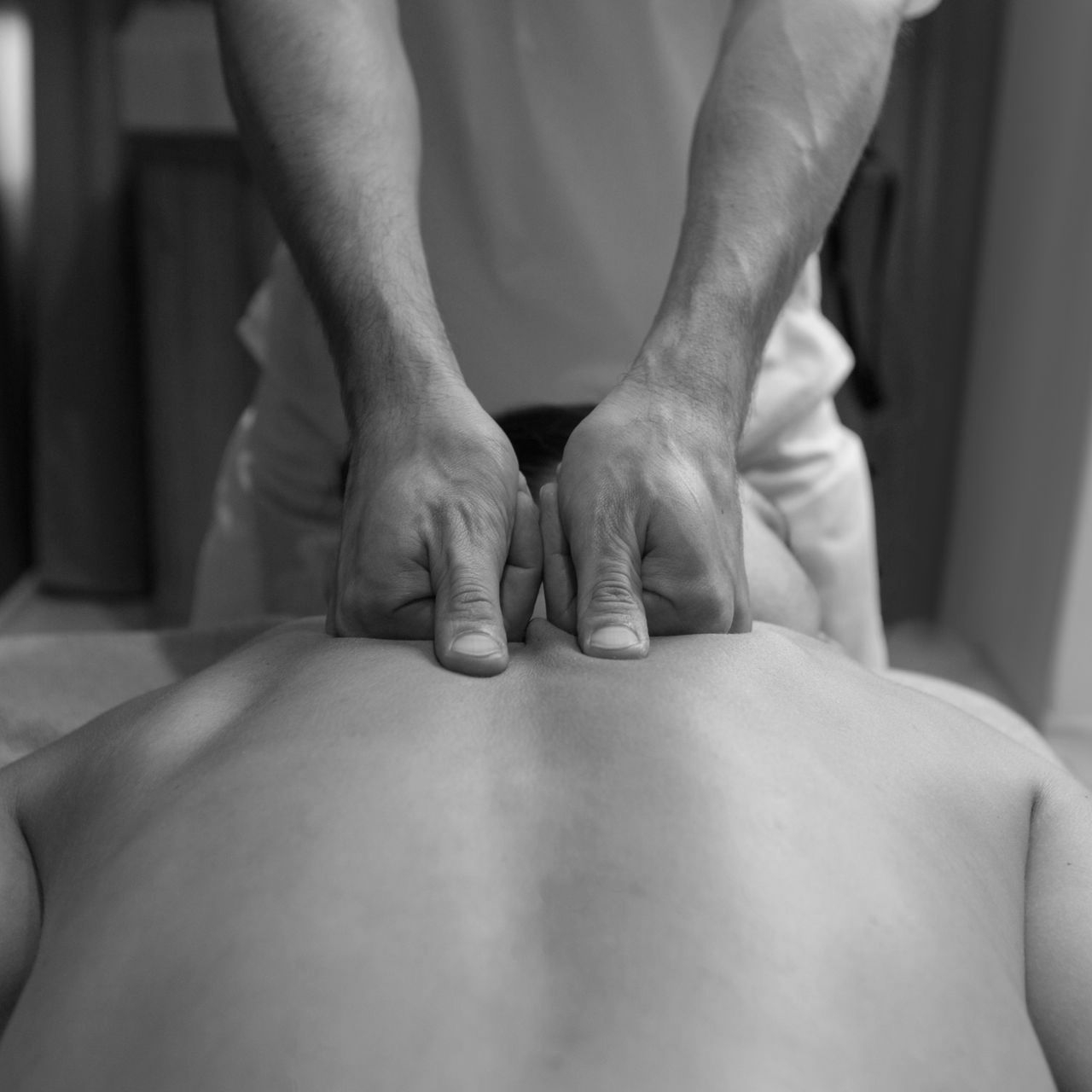 a man is giving a woman a massage on her back .