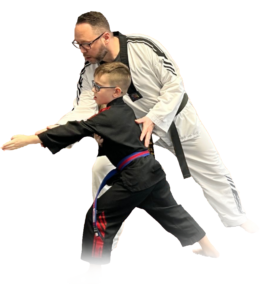 A man and a boy are practicing martial arts together.