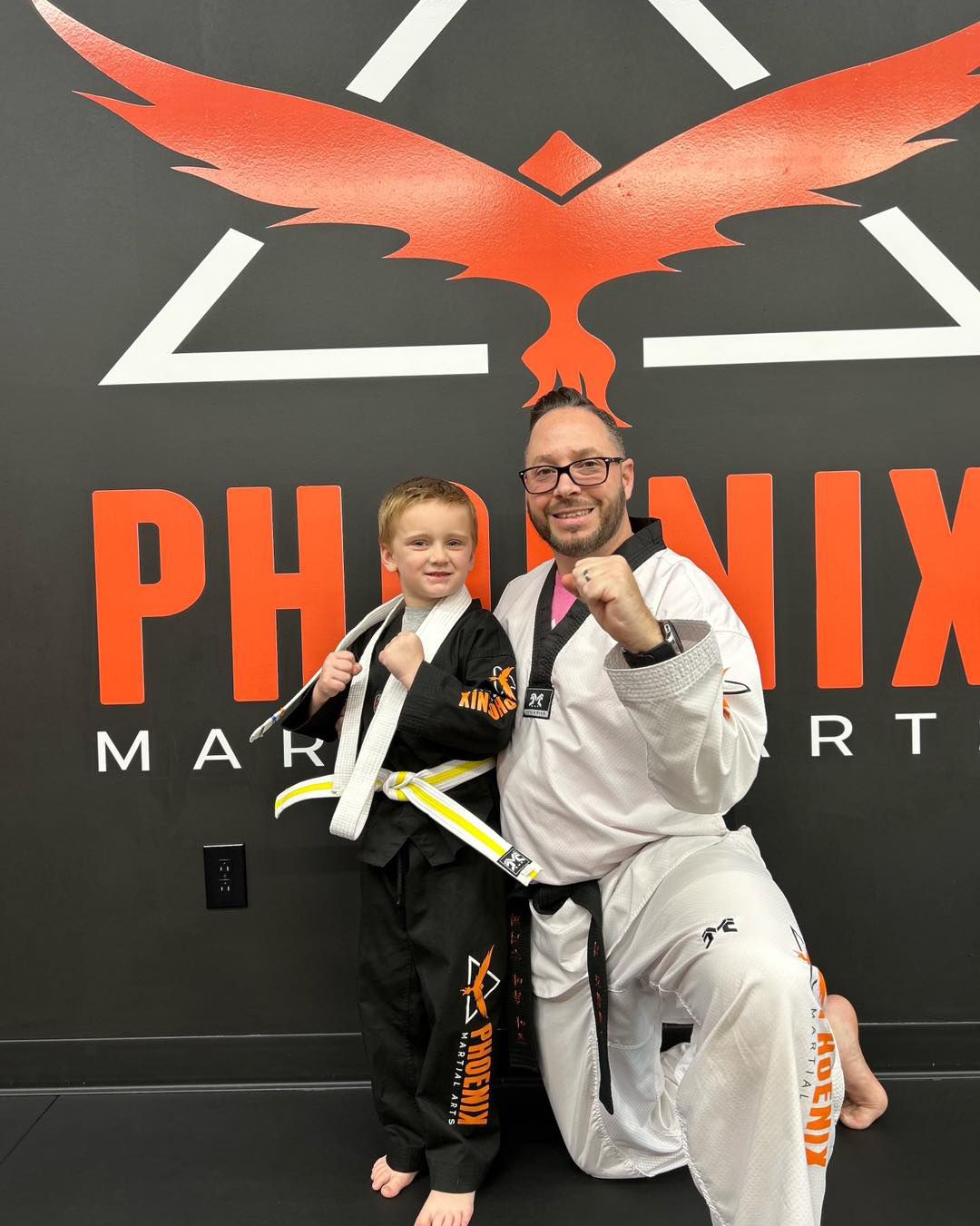 A group of people are posing for a picture with their arms in the air.