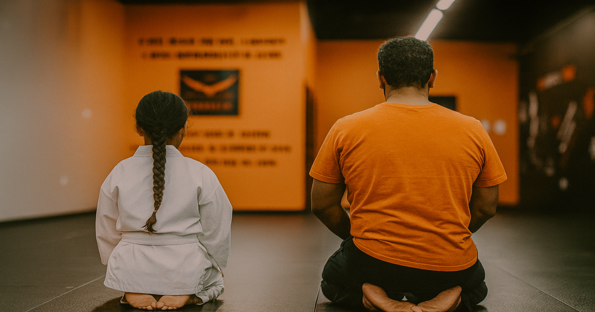 A parent and child kneel on martial arts mats at Phoenix Martial Arts in Murfreesboro, TN