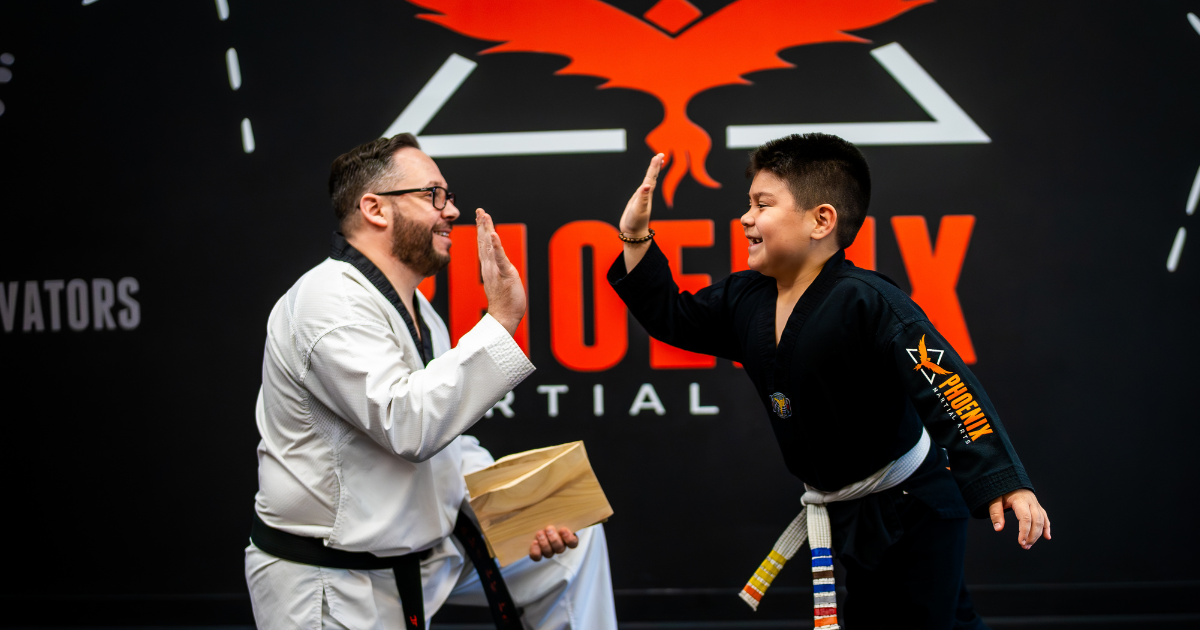 Master Nick Cotellese and student high five at Phoenix Martial Arts in Murfreesboro, TN.