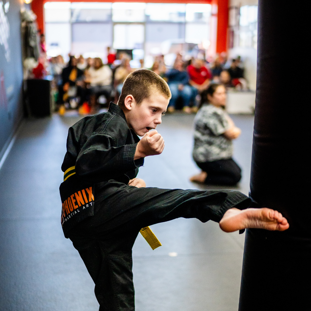 A boy and a girl are practicing taekwondo together.