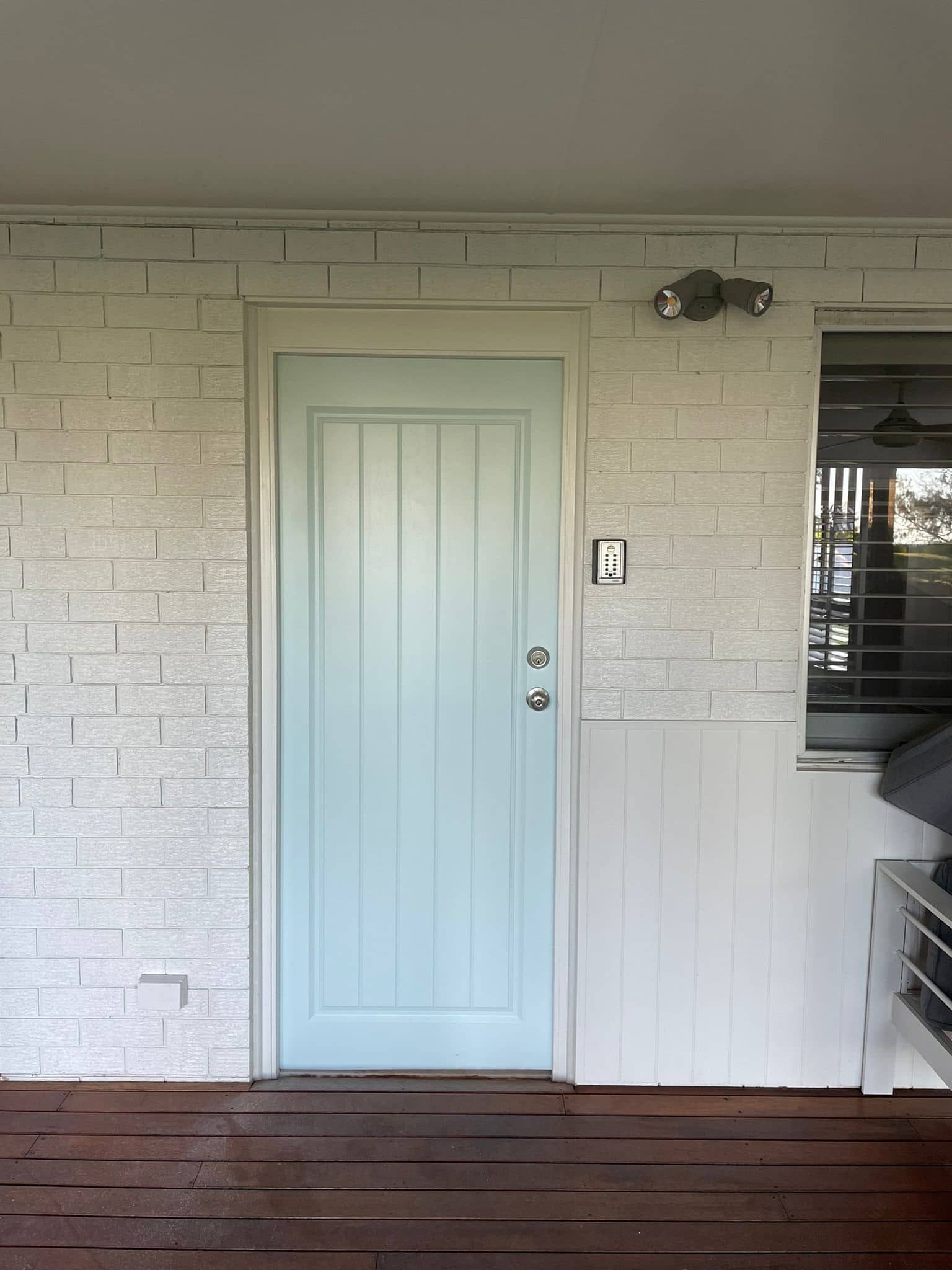 A Living Room With A Door And A Gray Wall — Tweed Heads Painting Service In Condong, NSW