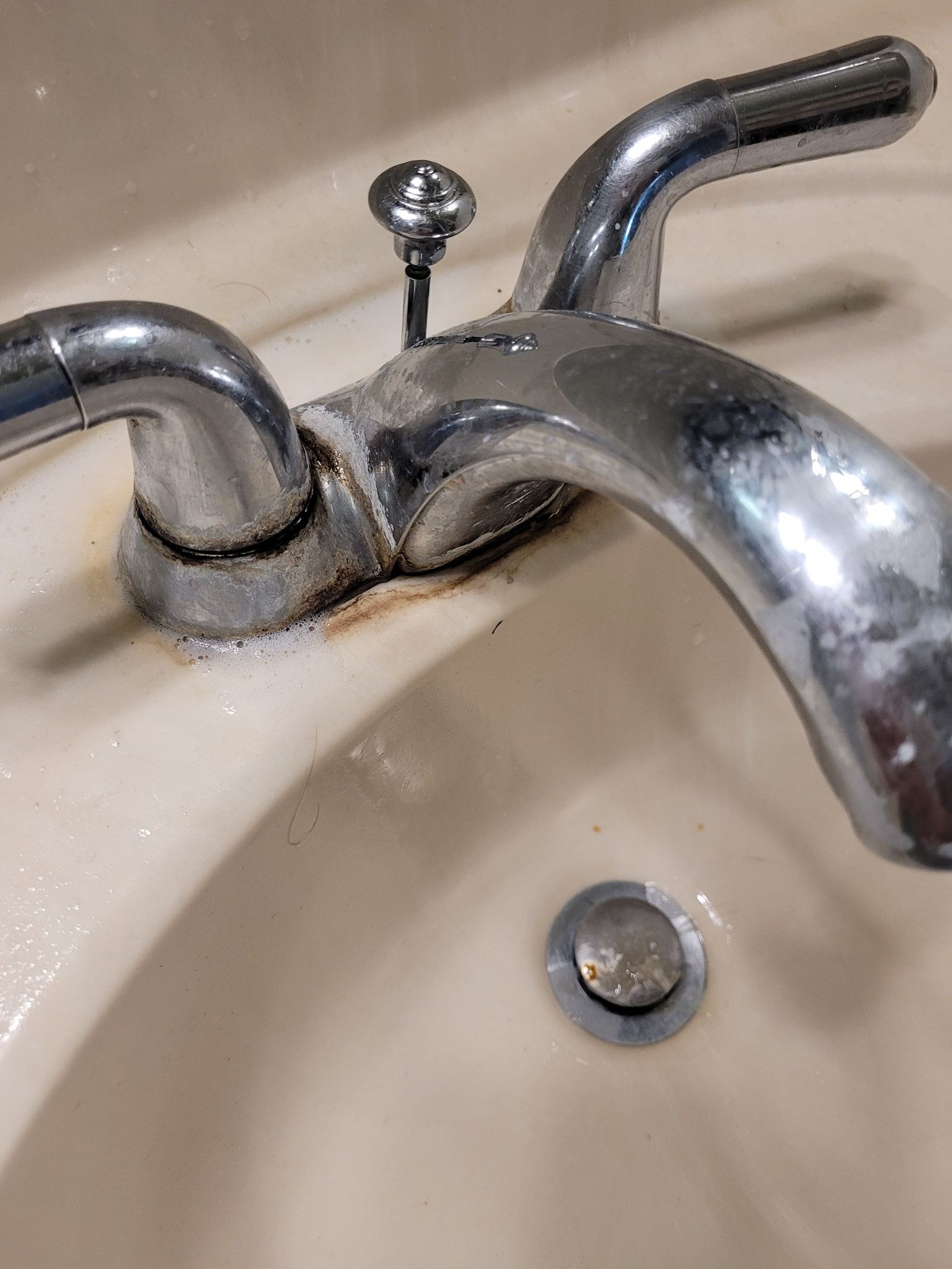 A close up of a faucet on a bathroom sink.
