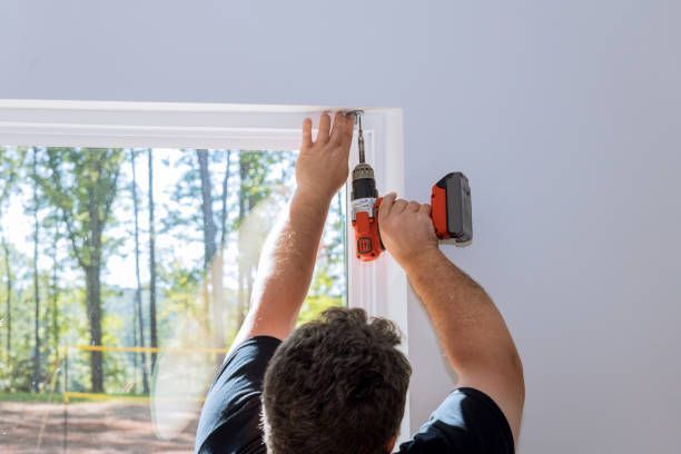 Technician installing window fixings, showcasing window replacement in a home.