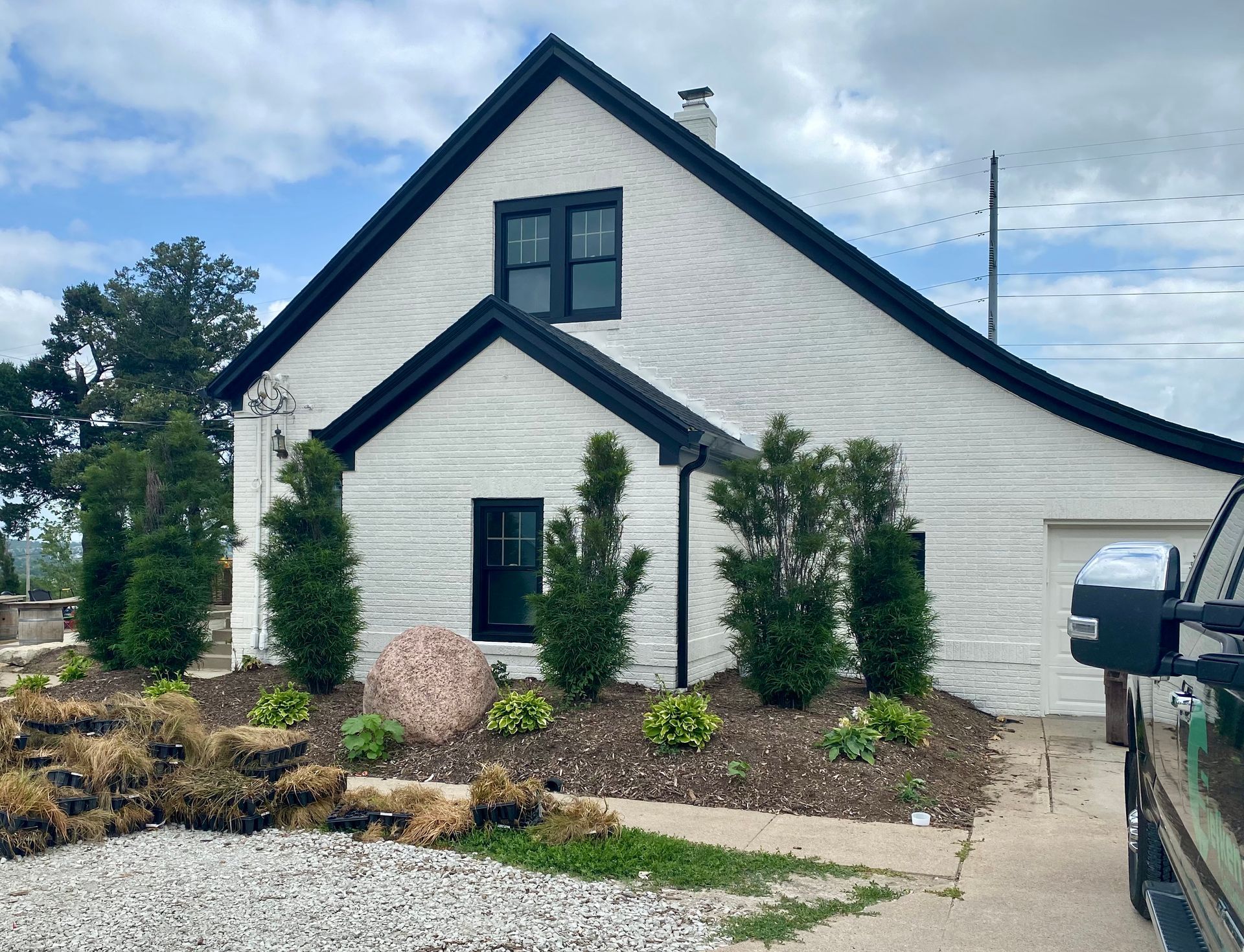 A white house with black trim | Siefken Roofing and Remodeling Services in Omaha, NE