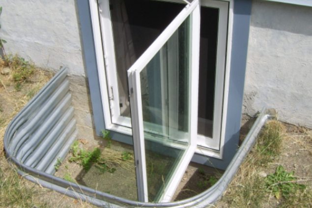 A bedroom with a bed , chair , and a balcony | Siefken Roofing and Remodeling Services in Omaha, NE