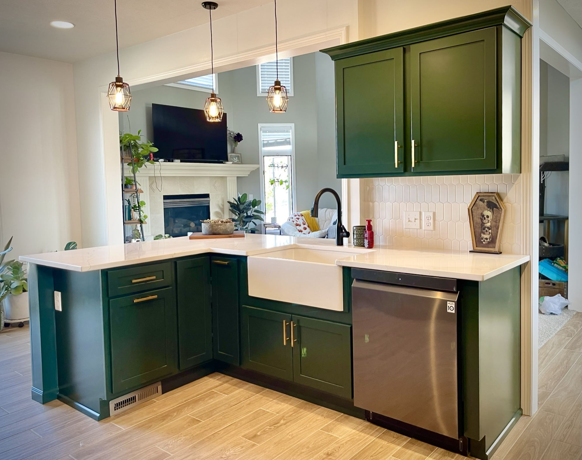 A kitchen with green cabinets and stainless steel appliances | Siefken Roofing and Remodeling Services in Omaha, NE