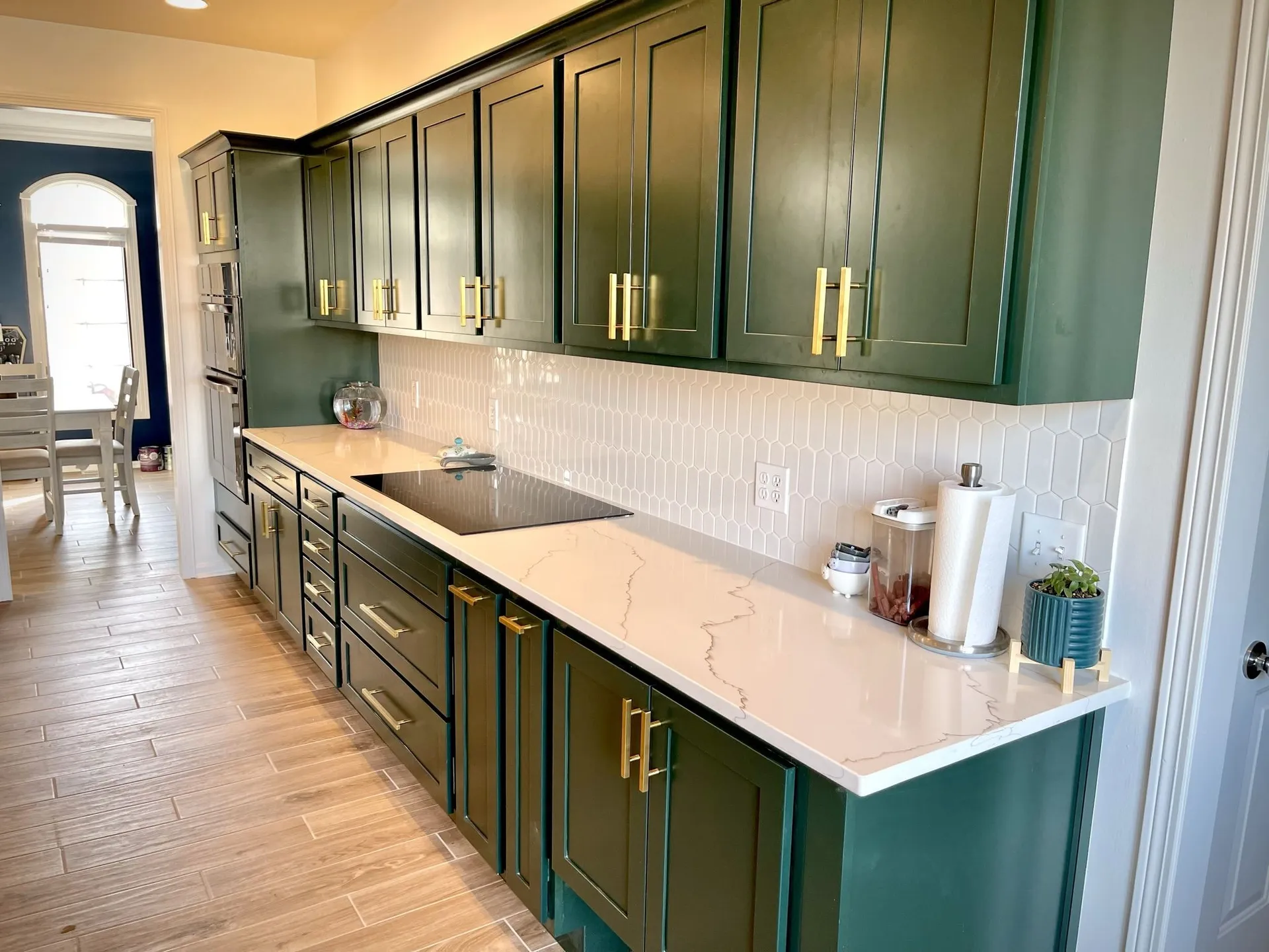 A kitchen with green cabinets and white counter tops | Kitchen Projects | Siefken Roofing and Remodeling Services in Omaha, NE