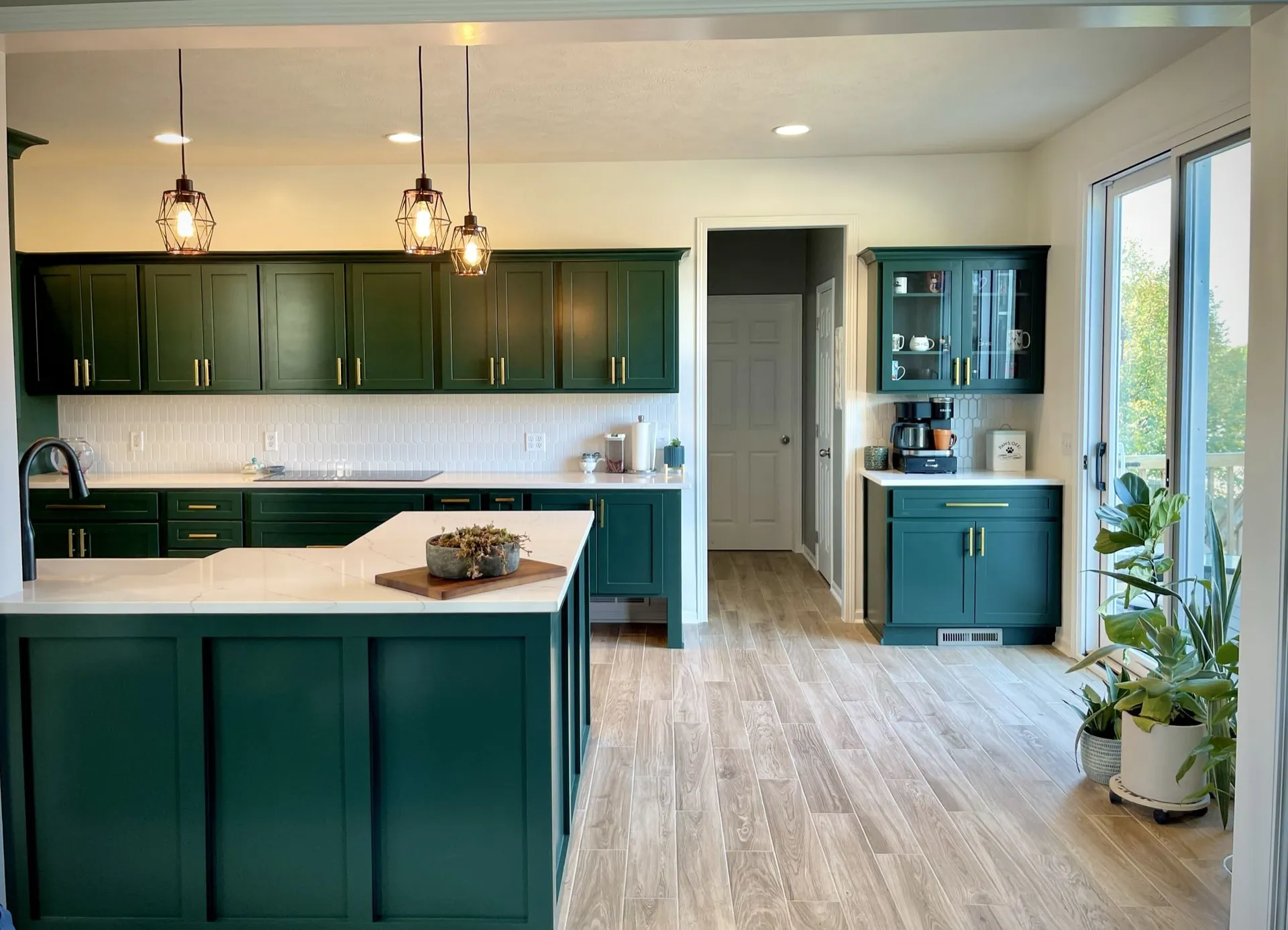 A kitchen with green cabinets and a large island  | Kitchen Projects | Siefken Roofing and Remodeling Services in Omaha, NE