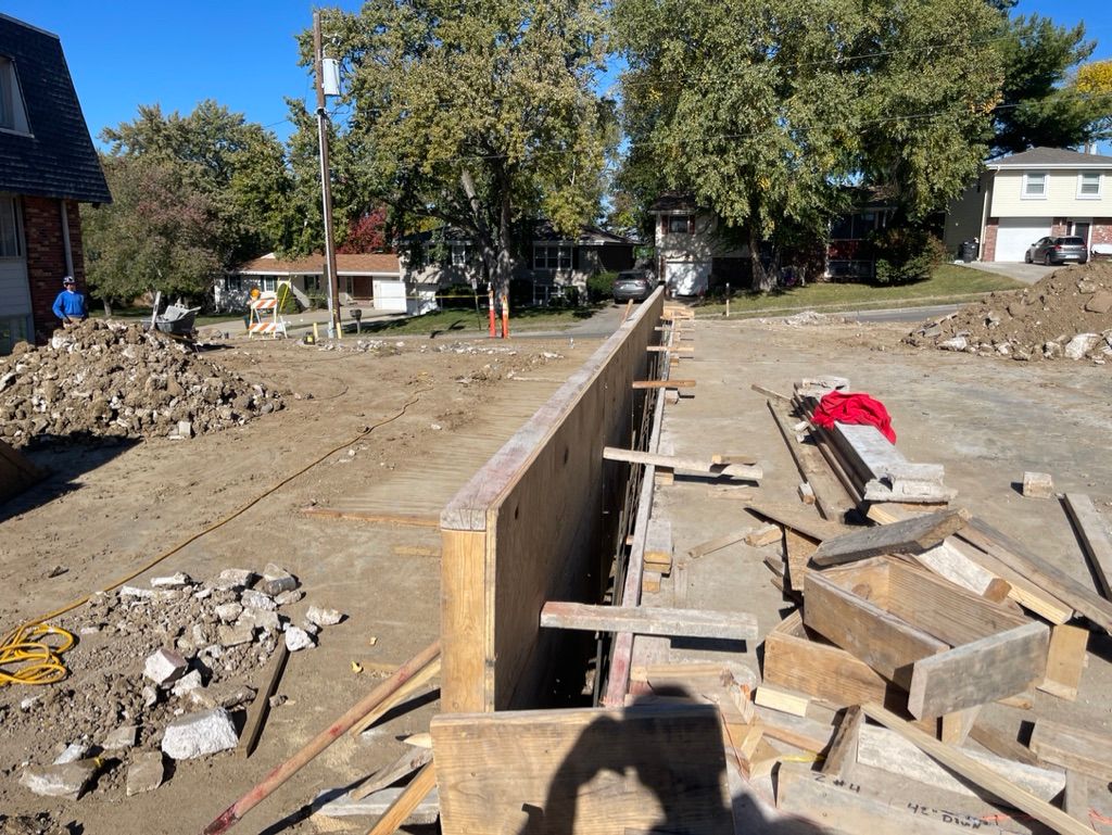 A concrete wall is being built in a construction site | Fire Restoration  Projects | Siefken Roofing and Remodeling Services in Omaha, NE