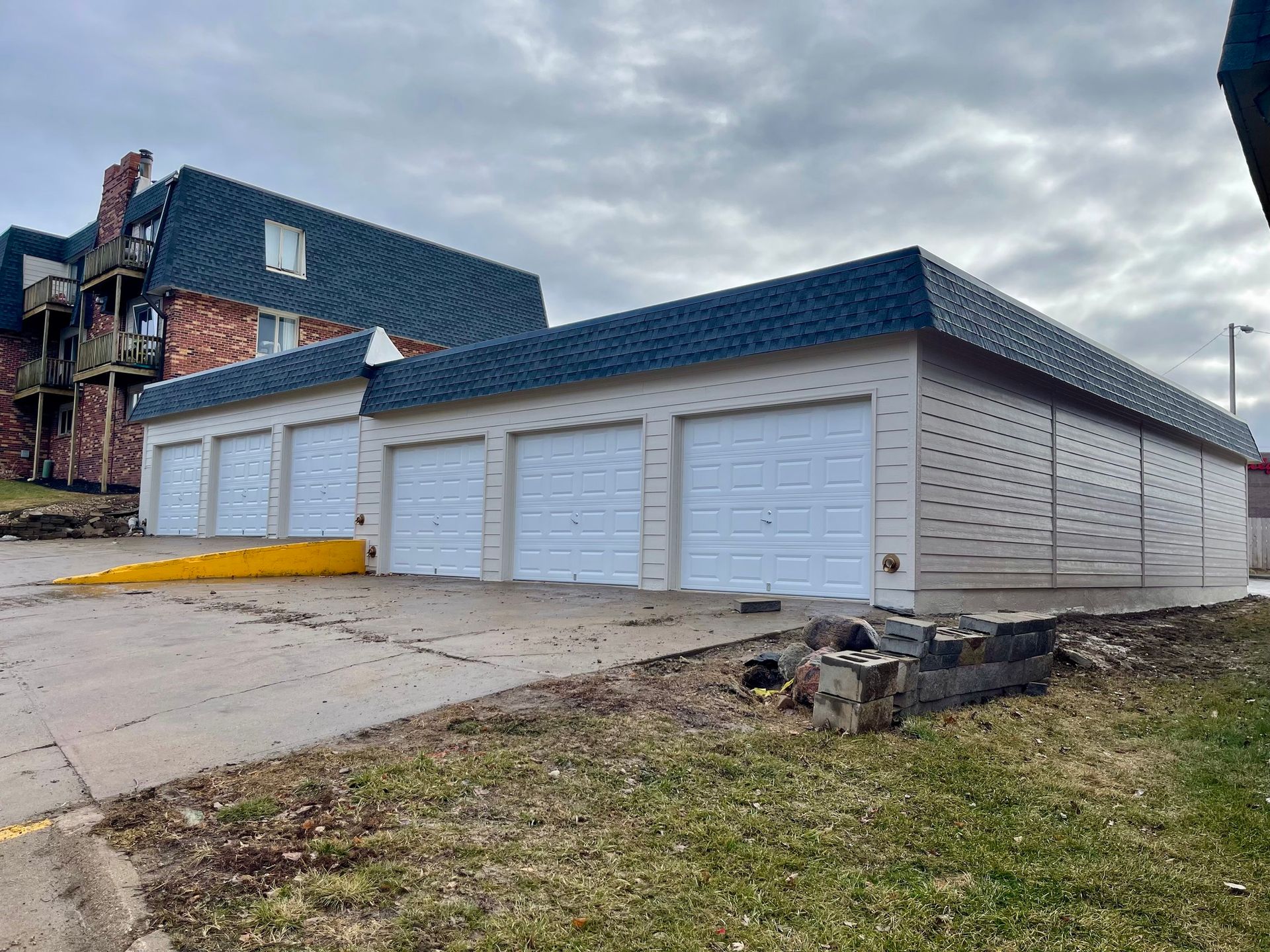 A garage with a blue roof and white garage doors | Fire Restoration  Projects | Siefken Roofing and Remodeling Services in Omaha, NE