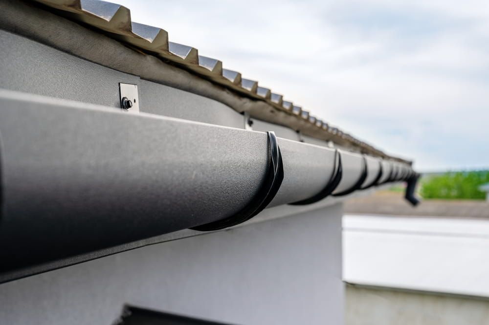 A Close up Of a Gutter on The Roof of A Building — South Coast Gutter Wiz in Nowra, NSW