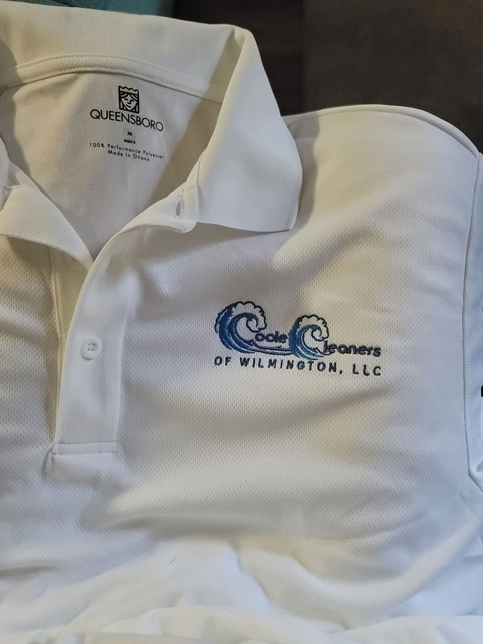 White polo shirt with blue logo: 