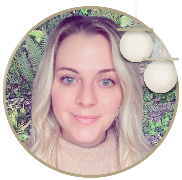 A woman 's face is in a circle surrounded by plants