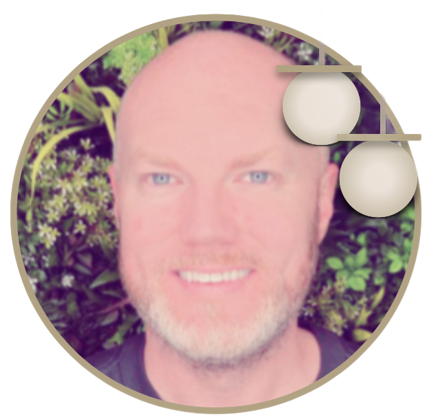 A bald man with a beard is smiling in a circle