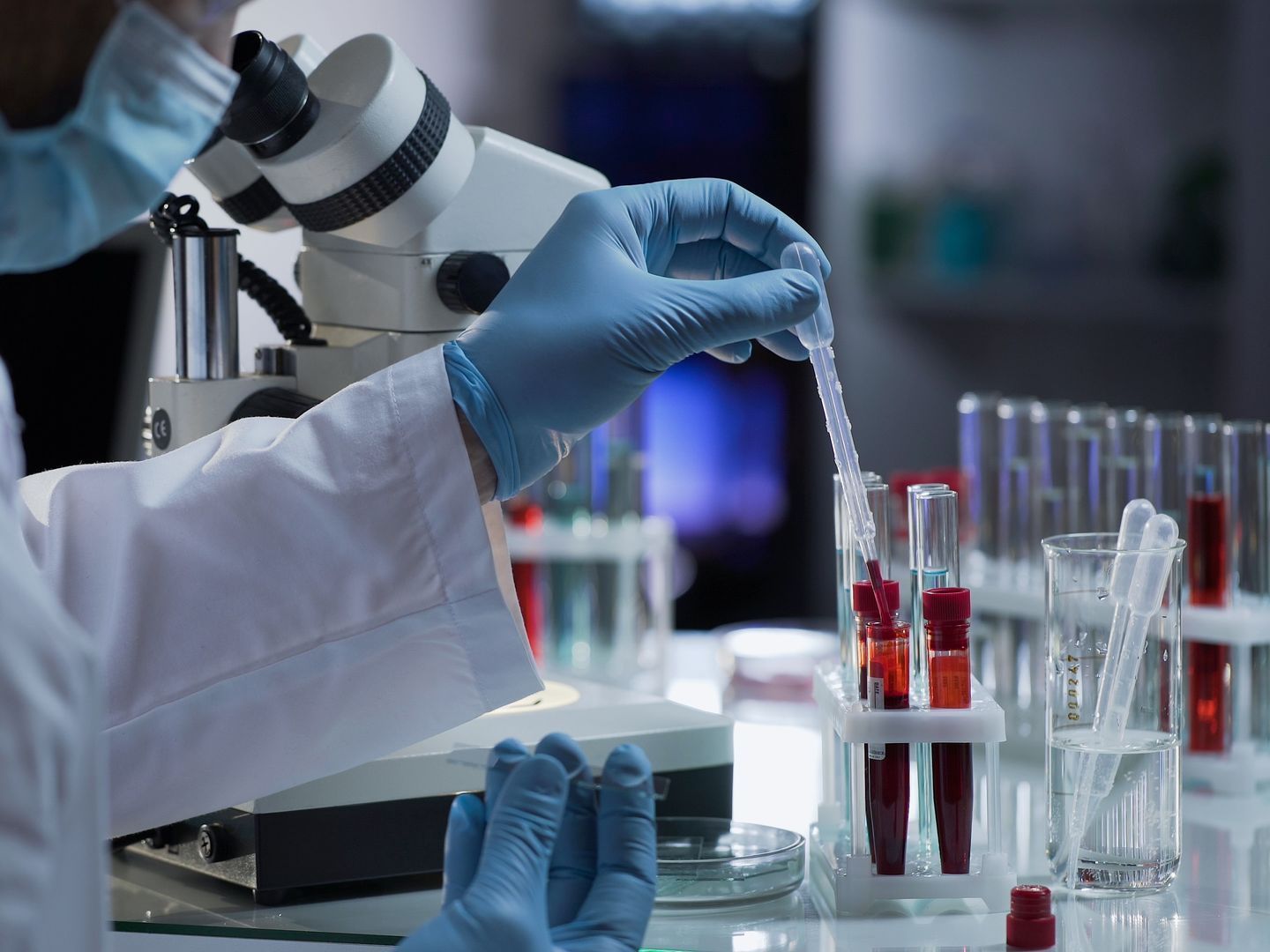 A scientist is looking through a microscope in a laboratory.