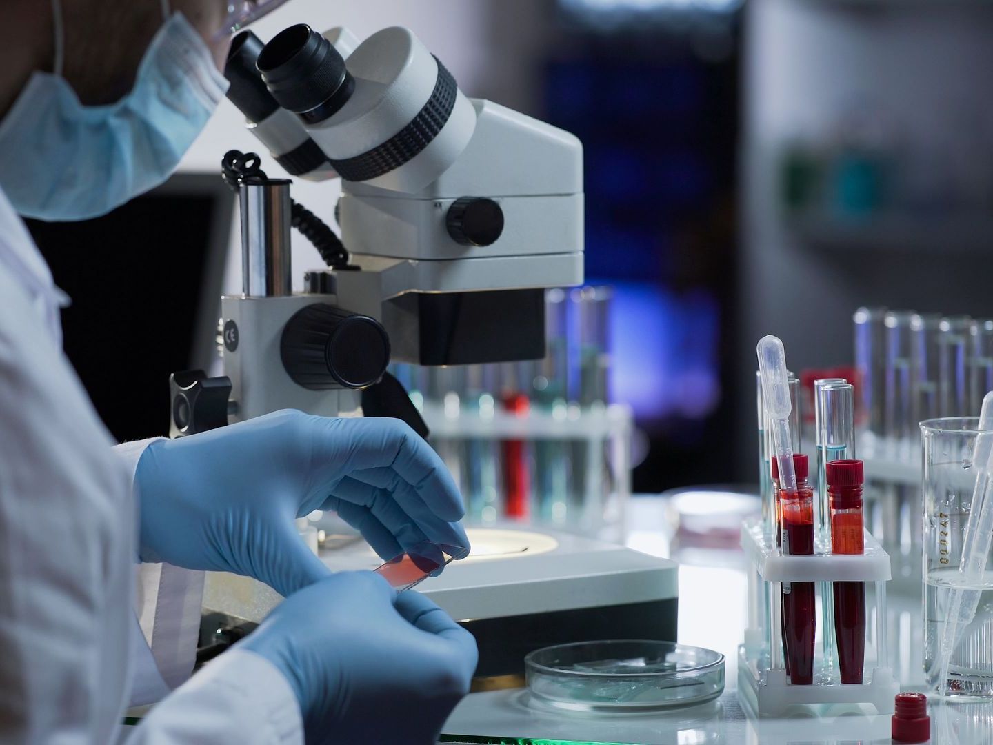 A scientist is looking through a microscope in a laboratory.