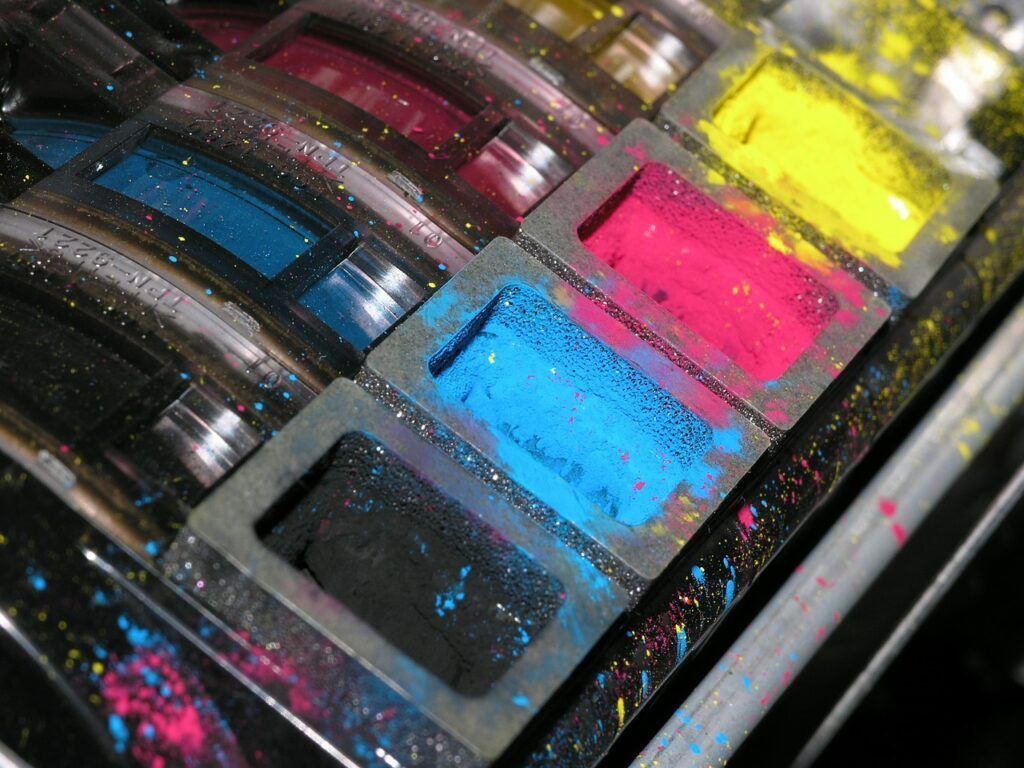 A close up of a row of colorful ink cartridges