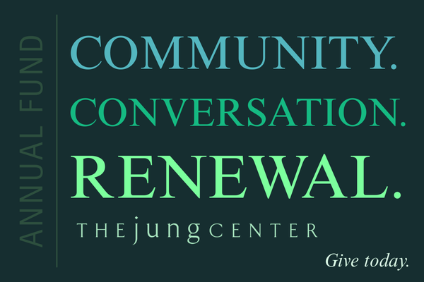 Gift box with red twine bow, on wood, surrounded by evergreen branches.