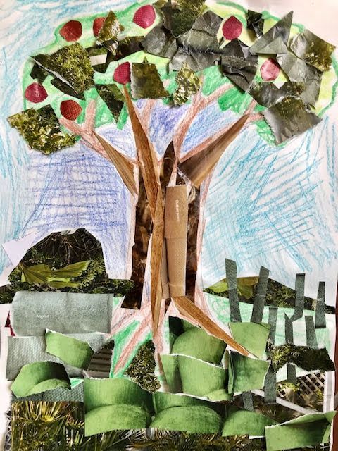 A child 's collage of an apple tree with a fence in the background