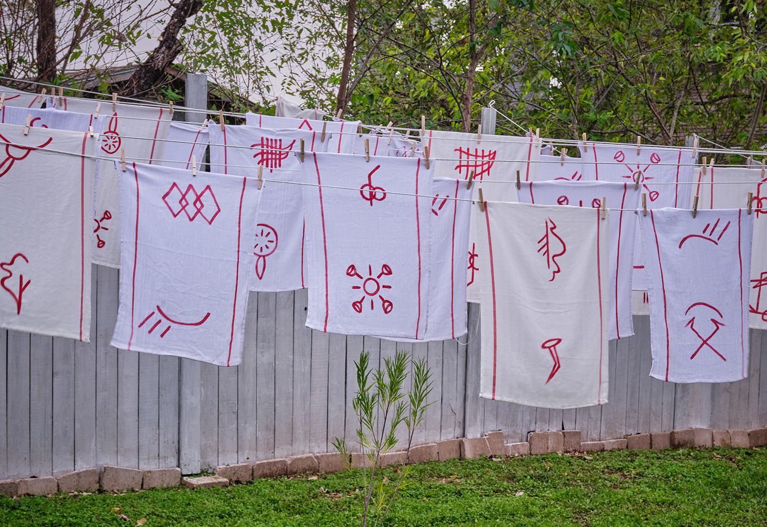 A bunch of towels are hanging on a clothes line.