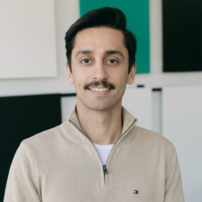 A man in a suit and tie is smiling for the camera.