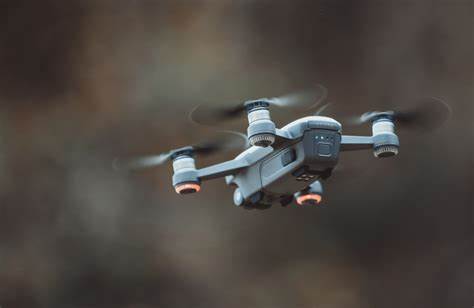 A small drone is flying in the air.
