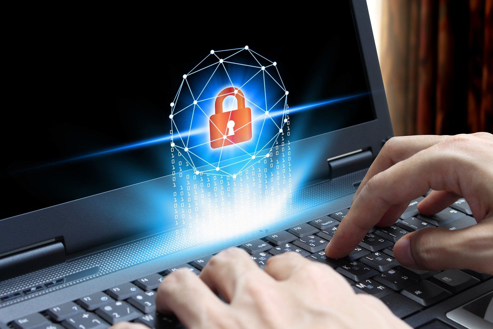 A person is typing on a laptop with a padlock coming out of the screen.