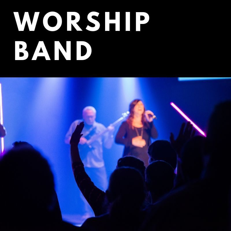 A worship band is performing on stage in front of a crowd.