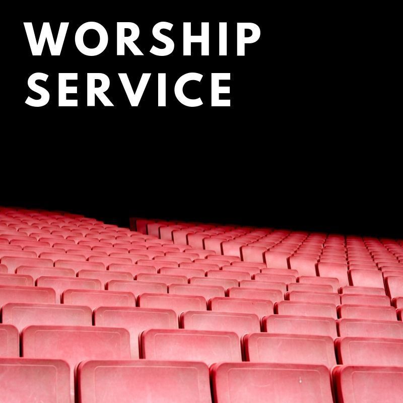 Rows of red seats in a theater with the words worship service above them