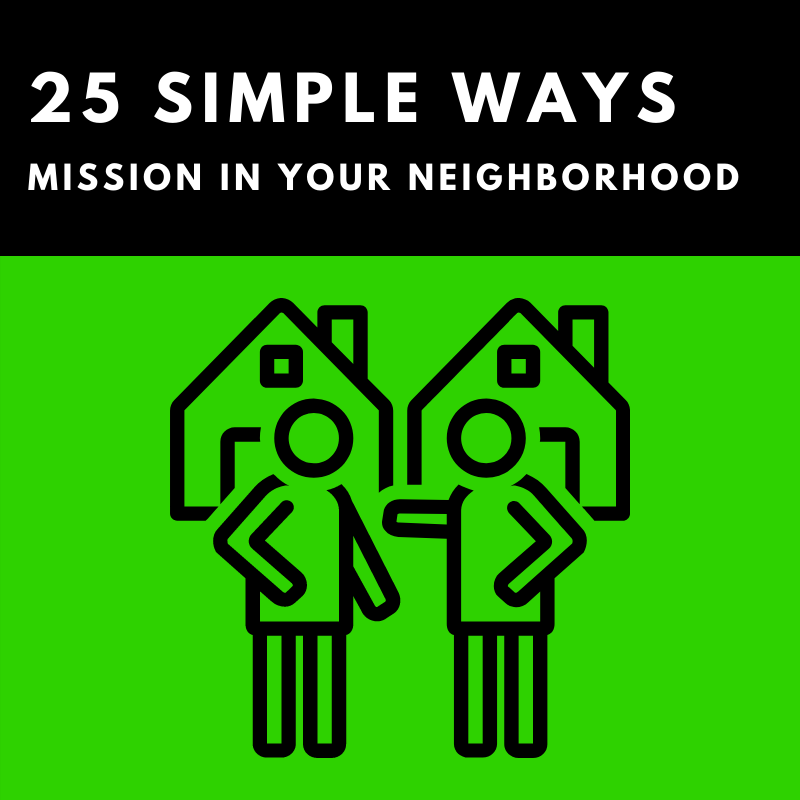 Two people are standing next to each other in front of two houses.