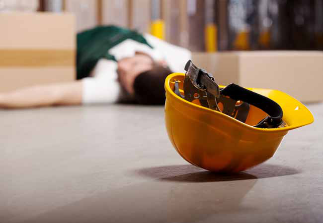 Worker laying on the floor of a warehouse