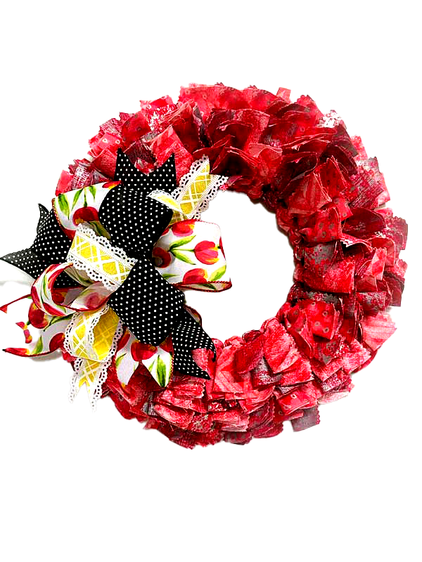 A red wreath with a black and white bow on a white background.